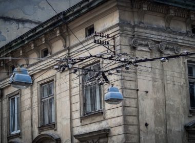 gray lamp with electrical cables near brown concrete building