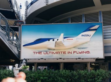 a billboard with a plane on it in front of a building