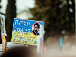 a protest sign with a picture of a man with a beard