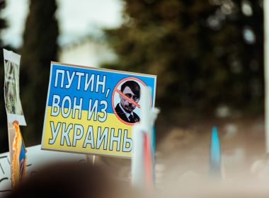 a protest sign with a picture of a man with a beard