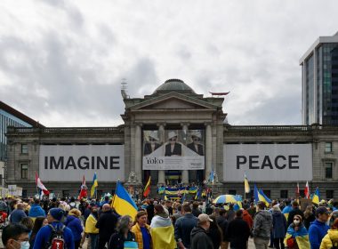 a crowd of people standing in front of a building